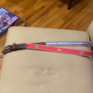 Peter Millar belt with 1956 on belt and golf clubs.